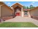 Inviting entrance showcasing brick accents, an arched entryway, and a red double-door entrance at 4469 Lake In The Woods Dr, Spring Hill, FL 34607