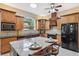 Well-equipped kitchen with granite countertops, dark appliances and a center island at 4469 Lake In The Woods Dr, Spring Hill, FL 34607