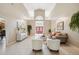 Airy living space showcasing tile flooring, an open layout, comfortable seating, and a grand entrance at 4469 Lake In The Woods Dr, Spring Hill, FL 34607