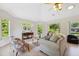 Bright living room with vaulted ceilings, natural light, and stylish furnishings at 4469 Lake In The Woods Dr, Spring Hill, FL 34607