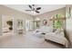 Inviting living room with arched windows, tile flooring, and comfortable seating at 4469 Lake In The Woods Dr, Spring Hill, FL 34607
