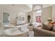Spacious living area with tile flooring, ample seating, stylish decor, and a view of the entryway at 4469 Lake In The Woods Dr, Spring Hill, FL 34607