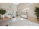 An open living area boasts lots of natural light, tile flooring, and an inviting seating arrangement at 4469 Lake In The Woods Dr, Spring Hill, FL 34607