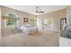Spacious main bedroom featuring arched windows, neutral colors, and ceiling fan at 4469 Lake In The Woods Dr, Spring Hill, FL 34607