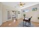 Bright office space with view of the bedroom featuring a desk and ceiling fan at 4469 Lake In The Woods Dr, Spring Hill, FL 34607