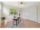 Bright office space featuring a desk, large windows, and a ceiling fan at 4469 Lake In The Woods Dr, Spring Hill, FL 34607
