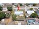 Aerial view of a home with a fenced backyard, patio and landscaping, in a residential neighborhood at 5031 Essex Ln, Spring Hill, FL 34606