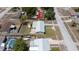 Aerial view of a home with a grey roof, manicured lawn, patio and landscaping, in a residential area at 5031 Essex Ln, Spring Hill, FL 34606