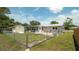 Spacious backyard featuring a shed, patio area, and chain link fence at 5031 Essex Ln, Spring Hill, FL 34606