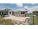 Backyard featuring a brick patio, some landscaping, a utility box, and a chain link fence at 5031 Essex Ln, Spring Hill, FL 34606