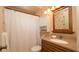Cozy bathroom with vanity, neutral colored tile, toilet, and shower with curtain at 5031 Essex Ln, Spring Hill, FL 34606