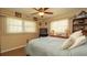 Cozy bedroom with wood floors, two windows and ceiling fan at 5031 Essex Ln, Spring Hill, FL 34606