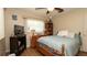 Bedroom with wood floors, two windows, ceiling fan, and a bookcase at 5031 Essex Ln, Spring Hill, FL 34606