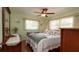 Green bedroom with white windows and ceiling fan at 5031 Essex Ln, Spring Hill, FL 34606