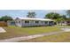 Charming single-story home with well-maintained lawn and metal roof at 5031 Essex Ln, Spring Hill, FL 34606