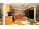 Kitchen featuring wooden cabinetry, tile backsplash, and modern black appliances at 5031 Essex Ln, Spring Hill, FL 34606