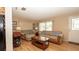 Cozy living room with comfortable sofas, natural light, and hardwood floors at 5031 Essex Ln, Spring Hill, FL 34606