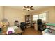 Comfortable home office with multiple desks, shelving, and natural light from the window at 5031 Essex Ln, Spring Hill, FL 34606
