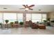 Bright sunroom with neutral tile floors, brick accents, and multiple windows for natural light at 5031 Essex Ln, Spring Hill, FL 34606