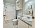 Compact bathroom featuring a shower-tub combo, vanity with sink, and medicine cabinet at 585 Sky Harbor Dr # 219, Clearwater, FL 33759