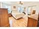 Bright bedroom with hardwood floors, ceiling fan, and mirrored closet doors at 585 Sky Harbor Dr # 219, Clearwater, FL 33759