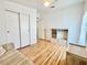 Bedroom with hardwood floors, ceiling fan, closet, and striped sofa at 585 Sky Harbor Dr # 219, Clearwater, FL 33759
