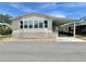 Well-maintained mobile home featuring a covered carport and manicured gravel landscaping at 585 Sky Harbor Dr # 219, Clearwater, FL 33759