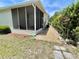 Exterior view of screened-in porch and yard with rock garden at 585 Sky Harbor Dr # 219, Clearwater, FL 33759