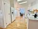 Well-lit kitchen featuring white appliances, marble countertops, and hardwood flooring at 585 Sky Harbor Dr # 219, Clearwater, FL 33759