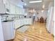 Open white kitchen featuring bright natural light and hardwood flooring at 585 Sky Harbor Dr # 219, Clearwater, FL 33759