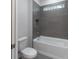 Bathroom featuring gray subway tile, a soaking tub and modern fixtures at 6063 Dusk Rose Ln, Brooksville, FL 34601