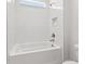 Bright bathroom featuring white subway tile, a soaking tub and modern fixtures at 6063 Dusk Rose Ln, Brooksville, FL 34601