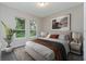 Cozy bedroom with natural light, neutral tones, and stylish decor creating a peaceful retreat at 6063 Dusk Rose Ln, Brooksville, FL 34601