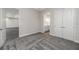 Bedroom with gray carpet and open doorways and a double door closet at 6063 Dusk Rose Ln, Brooksville, FL 34601