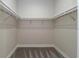 Walk-in closet with white shelving and carpeted floor, offering ample storage space at 6063 Dusk Rose Ln, Brooksville, FL 34601
