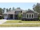 Charming single-story home featuring a manicured lawn, stone accents, and a welcoming front entrance at 6063 Dusk Rose Ln, Brooksville, FL 34601