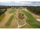 Expansive view of a golf course with rolling greens, sand traps and manicured fairways from above at 6063 Dusk Rose Ln, Brooksville, FL 34601