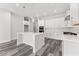 Beautiful kitchen with large island, white cabinets, stainless steel appliances, and stylish pendant lights at 6063 Dusk Rose Ln, Brooksville, FL 34601