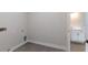 Tiled laundry room with base trim, utility connections and open access to a bathroom at 6063 Dusk Rose Ln, Brooksville, FL 34601