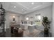 Bright home office featuring recessed lighting, large windows, desk, and elegant decor at 6063 Dusk Rose Ln, Brooksville, FL 34601