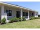 The rear of the house has a covered patio with columns and a well-maintained green lawn at 6063 Dusk Rose Ln, Brooksville, FL 34601