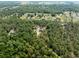 An aerial view shows a neighborhood surrounded by green space and mature trees at 6080 Dexter Ln, Brooksville, FL 34602