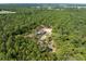 Overhead view features the property and house surrounded by gorgeous green trees at 6080 Dexter Ln, Brooksville, FL 34602