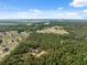 Expansive aerial view of a home nestled within a lush forest, boasting seclusion and natural beauty at 6080 Dexter Ln, Brooksville, FL 34602
