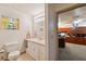 Bright bathroom featuring a white vanity and adjacent office space at 6080 Dexter Ln, Brooksville, FL 34602