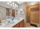 Bathroom featuring dual sinks, tiled shower, and soaking tub at 6080 Dexter Ln, Brooksville, FL 34602