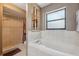 Bathroom featuring soaking tub and tiled shower at 6080 Dexter Ln, Brooksville, FL 34602