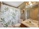 Bathroom featuring a vanity, toilet, and shower with a leafy shower curtain at 6080 Dexter Ln, Brooksville, FL 34602
