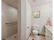 Bathroom features a walk-in shower, white toilet, and a vanity with a sink at 6080 Dexter Ln, Brooksville, FL 34602