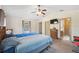 Main bedroom features a ceiling fan, television, and closet at 6080 Dexter Ln, Brooksville, FL 34602